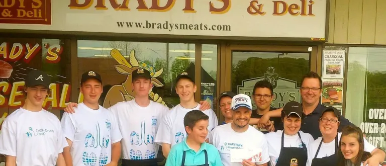 The Brady's staff and Mike Farwell outside the shop, wearing Cystic Fibrosis Ontario t-shirts