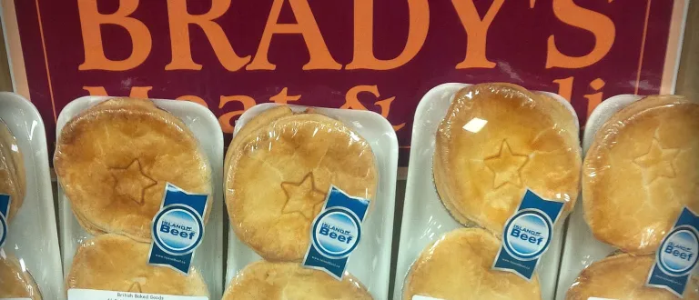 Five packages of beef pie with the Brady's logo in the background.