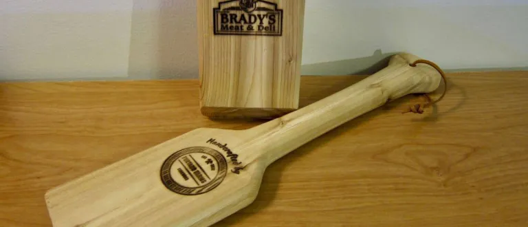 Two cedarwood BBQ cleaners with the Brady's logo on one side; and the Furtado logo on the other.