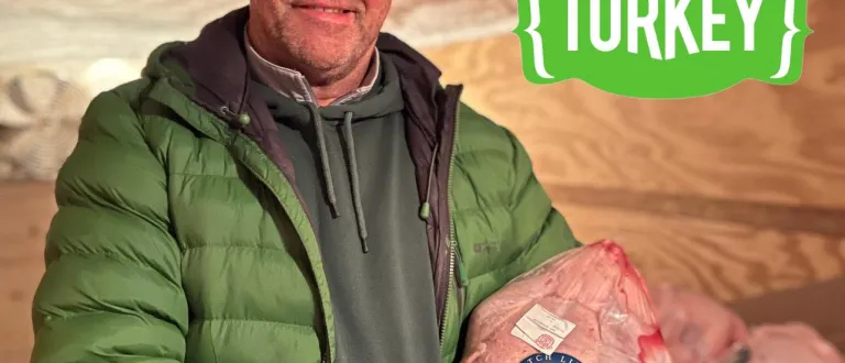 Rob Brady holding a fresh Scotch Line Turkey Company turkey, with the Ontario Turkey logo